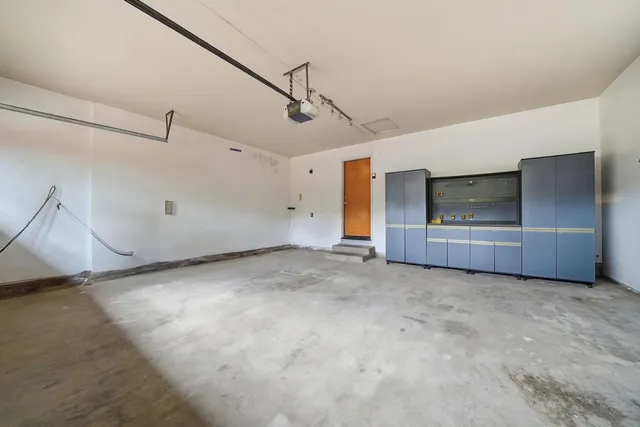 a backyard of a house with table and chairs