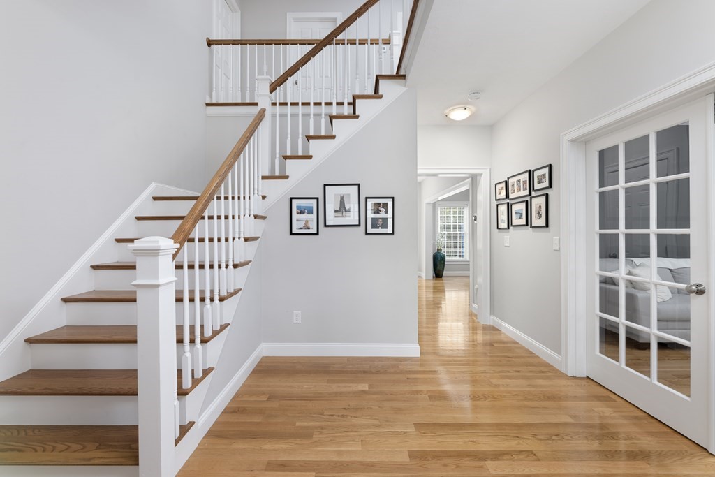 1 Pine House Road Millis, MA 02054 - Photo 2 of 33 a view of staircase with lots of frames on wall and wooden floor