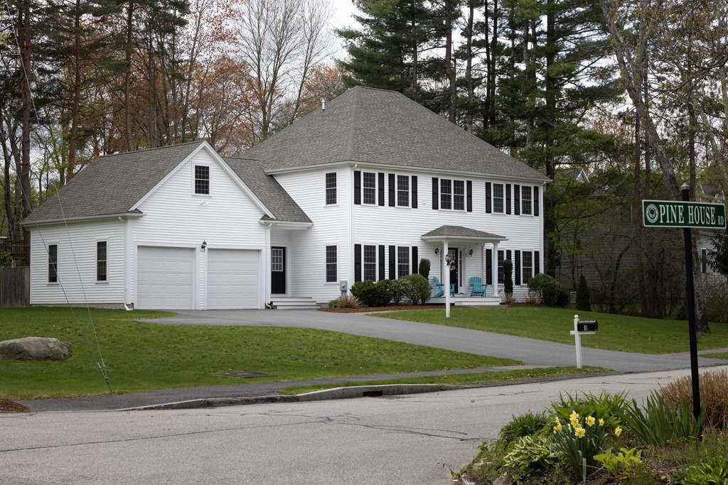 1 Pine House Road Millis, MA 02054 - Photo 24 of 33 a view of a white house in front of a yard with plants and large trees