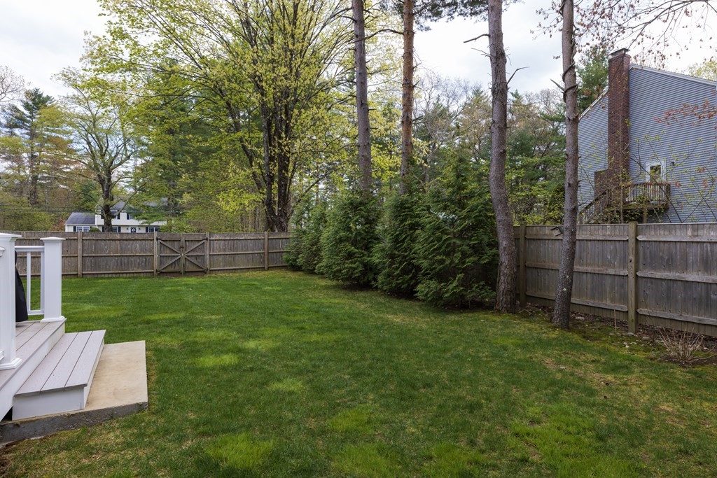 1 Pine House Road Millis, MA 02054 - Photo 30 of 33 a view of a backyard with wooden fence and a bench