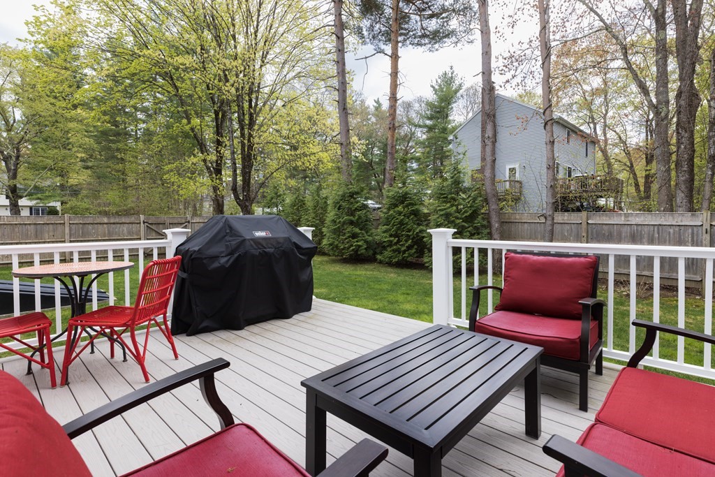 1 Pine House Road Millis, MA 02054 - Photo 32 of 33 a view of a roof deck with table and chairs and wooden floor