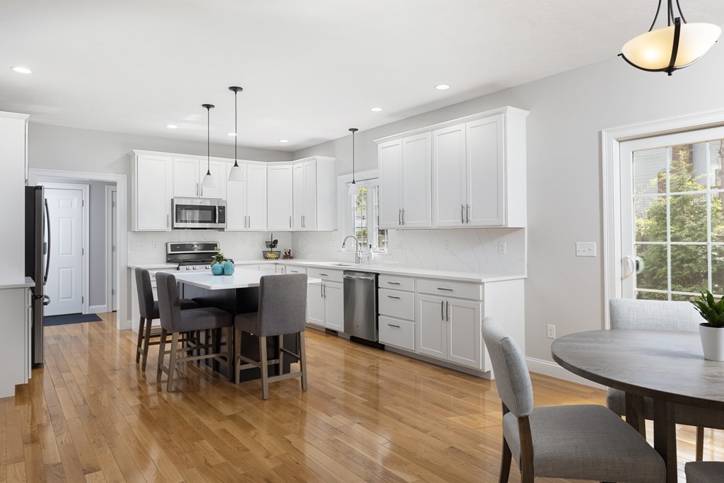 1 Pine House Road Millis, MA 02054 - Photo 4 of 33 a kitchen with stainless steel appliances a table chairs refrigerator and cabinets