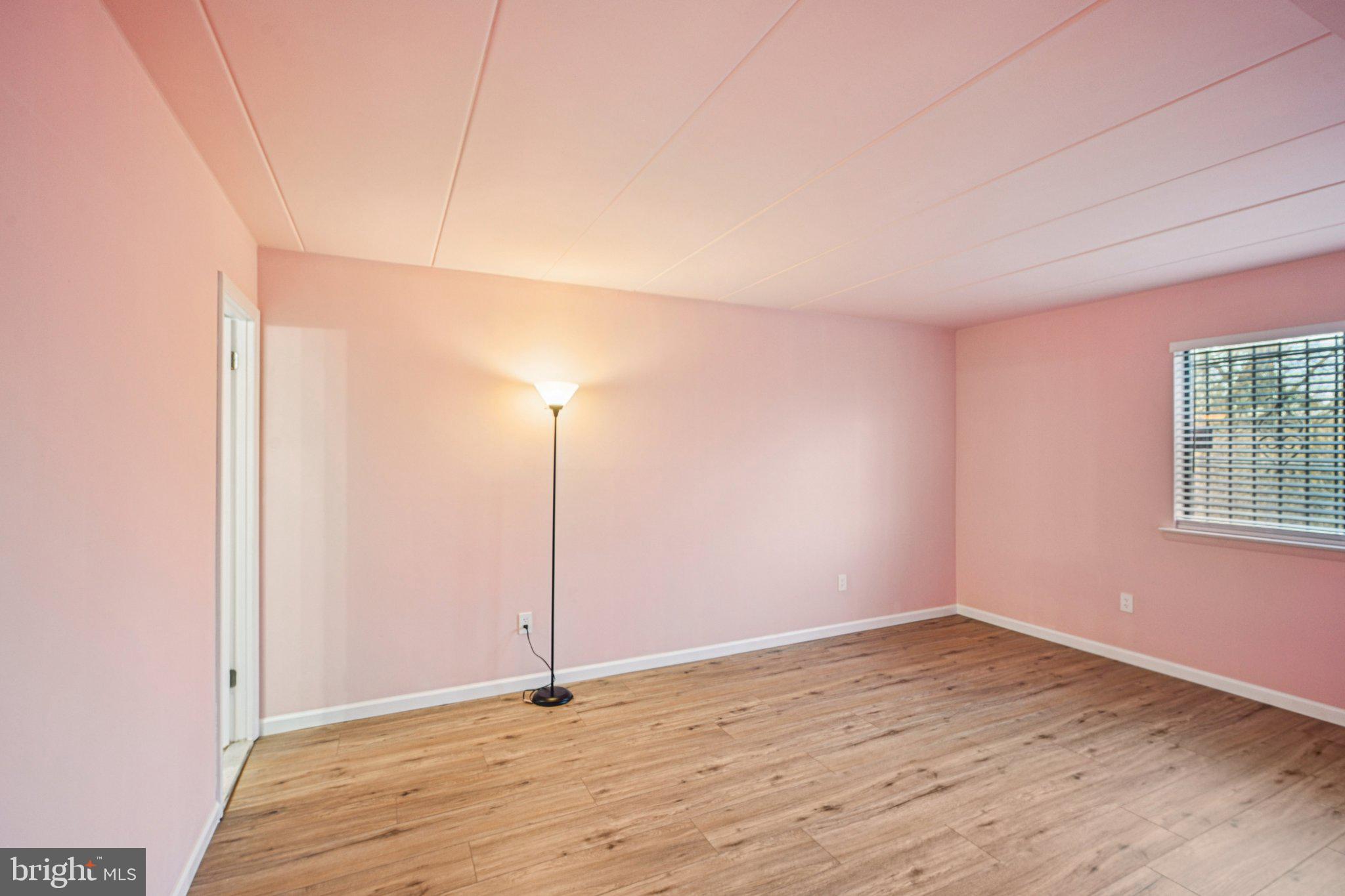 9906 Bustleton Avenue, Unit C25 Philadelphia, PA 19115 - Photo 15 of 26 a view of an empty room with wooden floor and a window