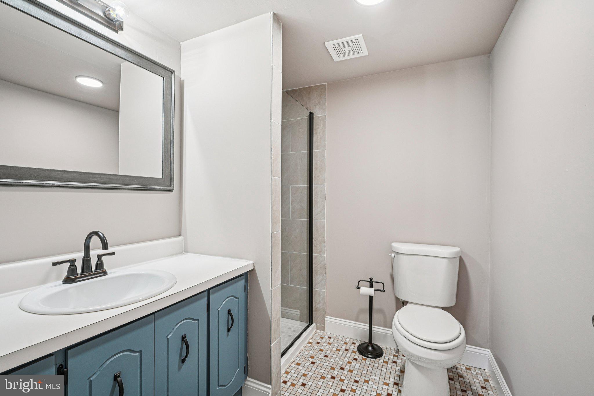 9906 Bustleton Avenue, Unit C25 Philadelphia, PA 19115 - Photo 18 of 26 a bathroom with a sink toilet and a mirror