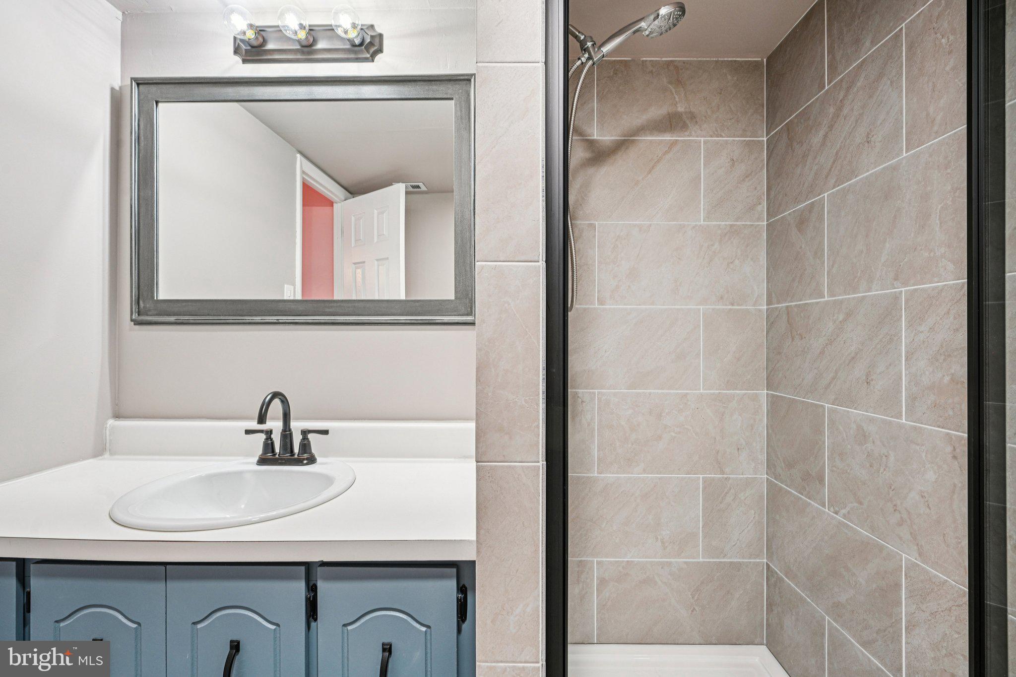 9906 Bustleton Avenue, Unit C25 Philadelphia, PA 19115 - Photo 19 of 26 a bathroom with a sink and a mirror