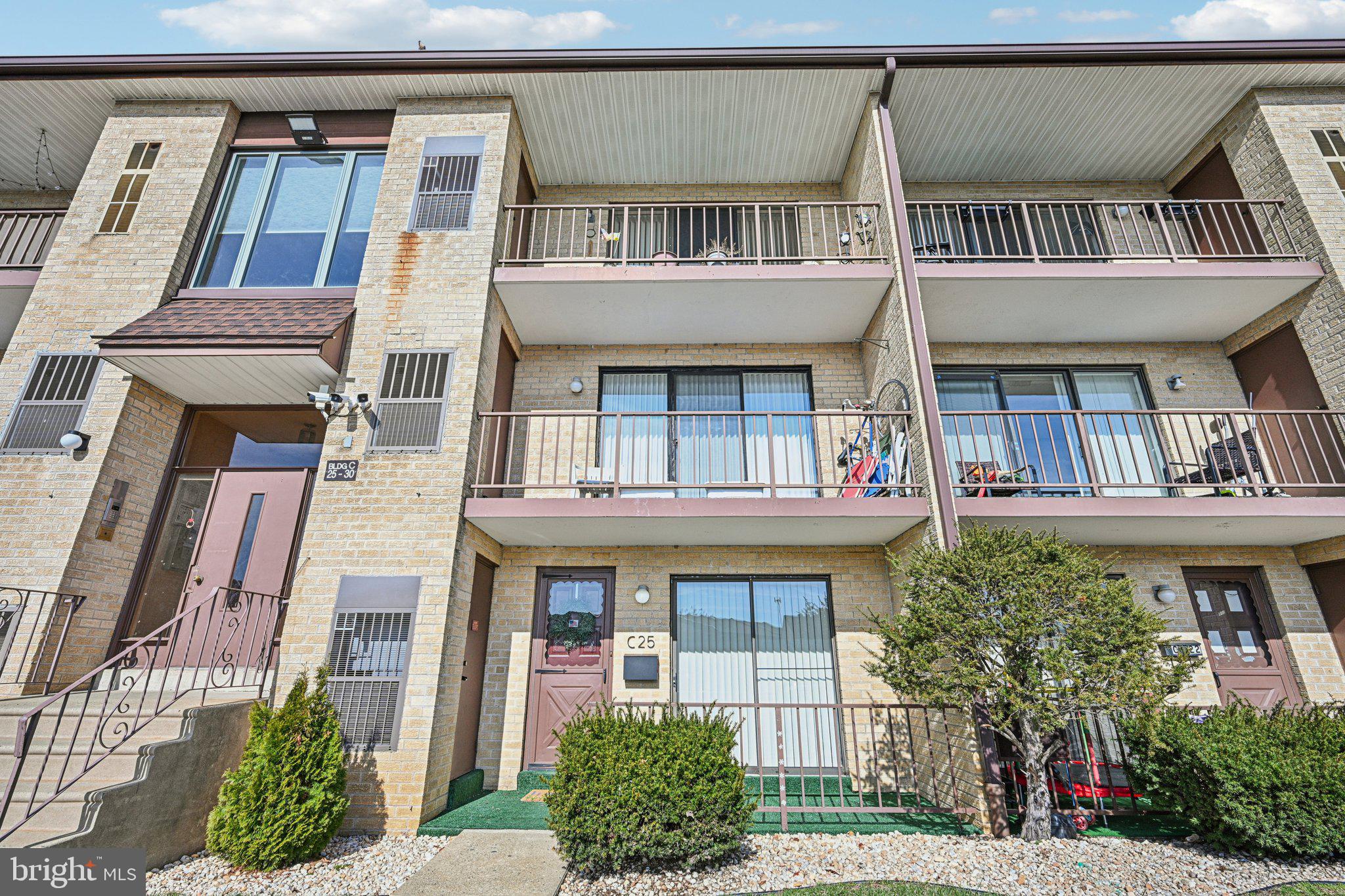 9906 Bustleton Avenue, Unit C25 Philadelphia, PA 19115 - Photo 2 of 26 a front view of a house with a garden