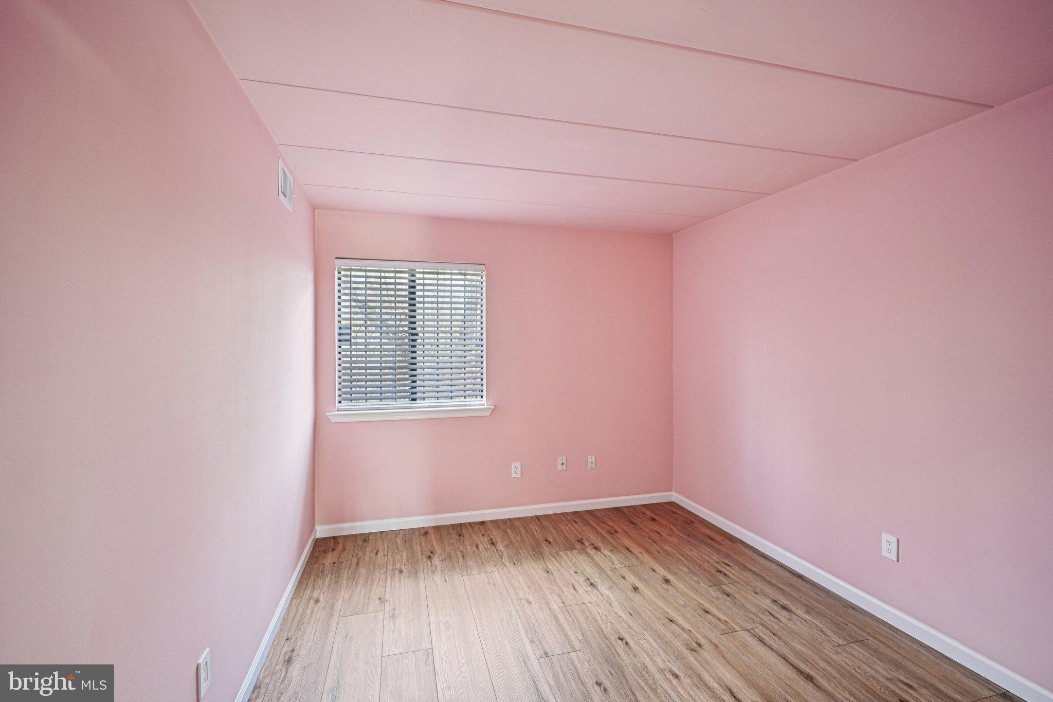 9906 Bustleton Avenue, Unit C25 Philadelphia, PA 19115 - Photo 20 of 26 a view of an empty room with wooden floor and a window
