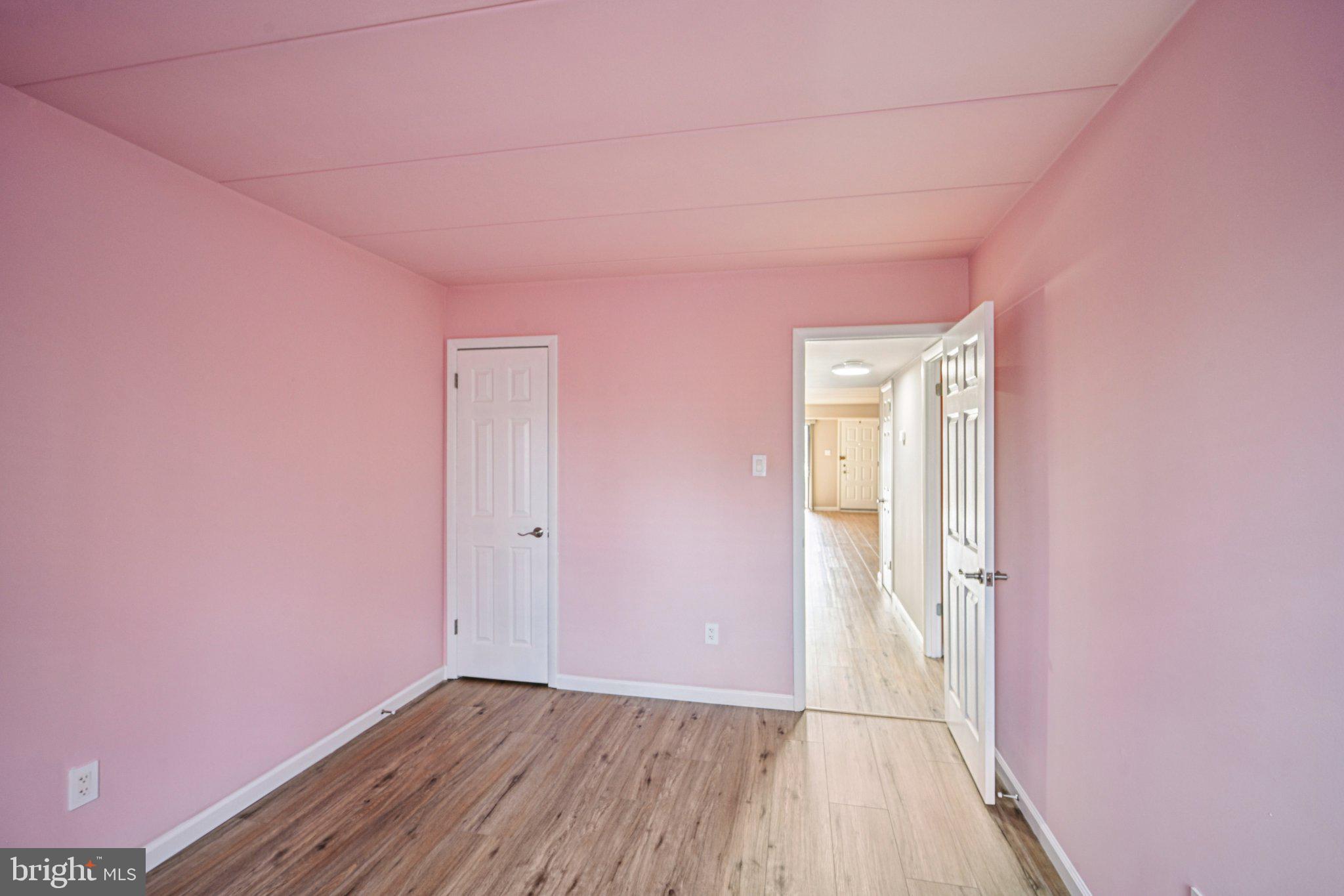 9906 Bustleton Avenue, Unit C25 Philadelphia, PA 19115 - Photo 21 of 26 a view of an empty room with wooden floor and a window
