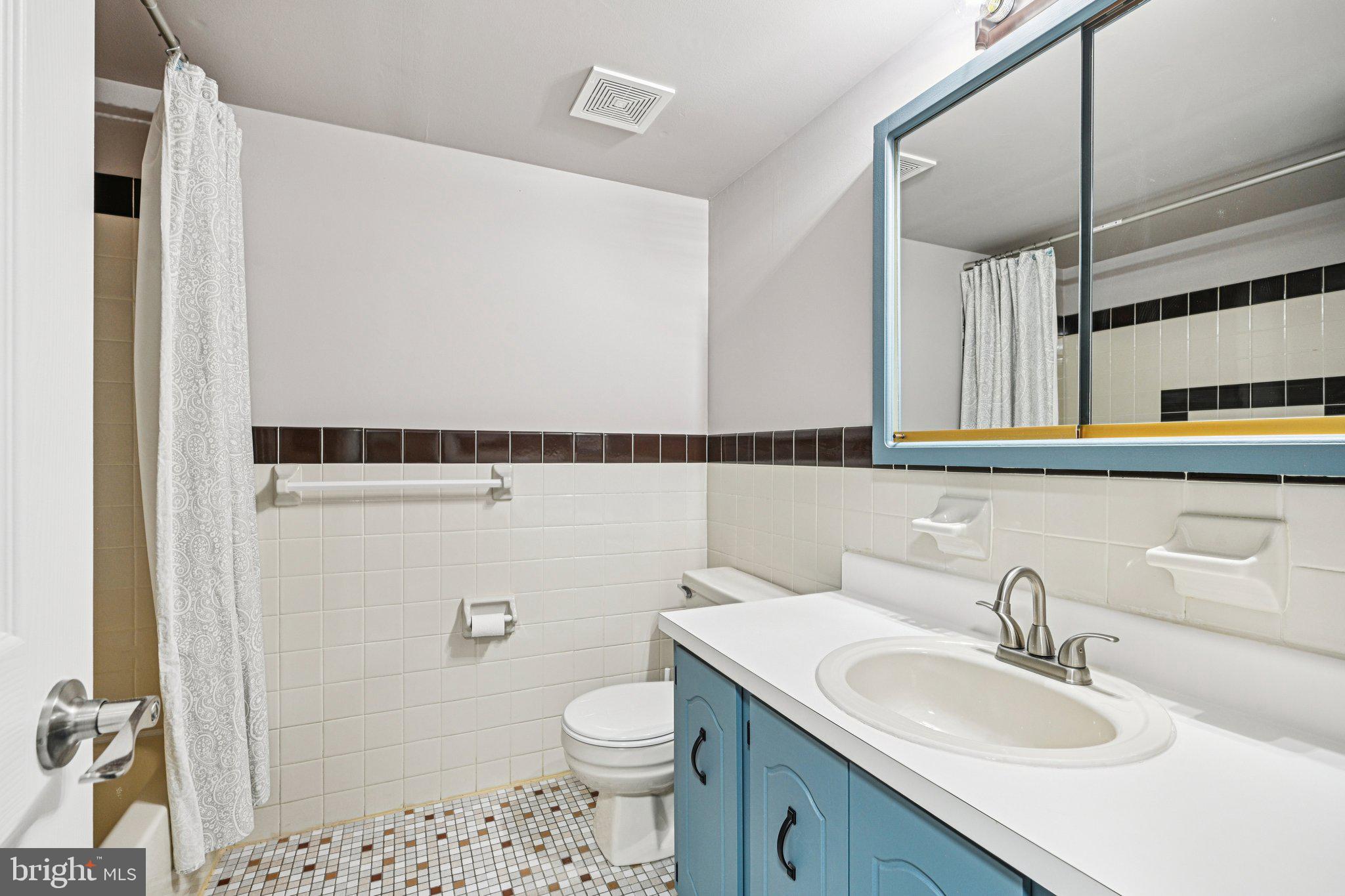 9906 Bustleton Avenue, Unit C25 Philadelphia, PA 19115 - Photo 22 of 26 a bathroom with a sink a toilet a mirror and shower