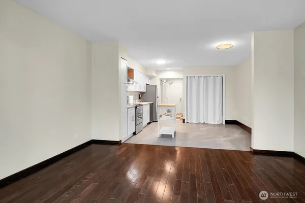 a view of empty room with wooden floor