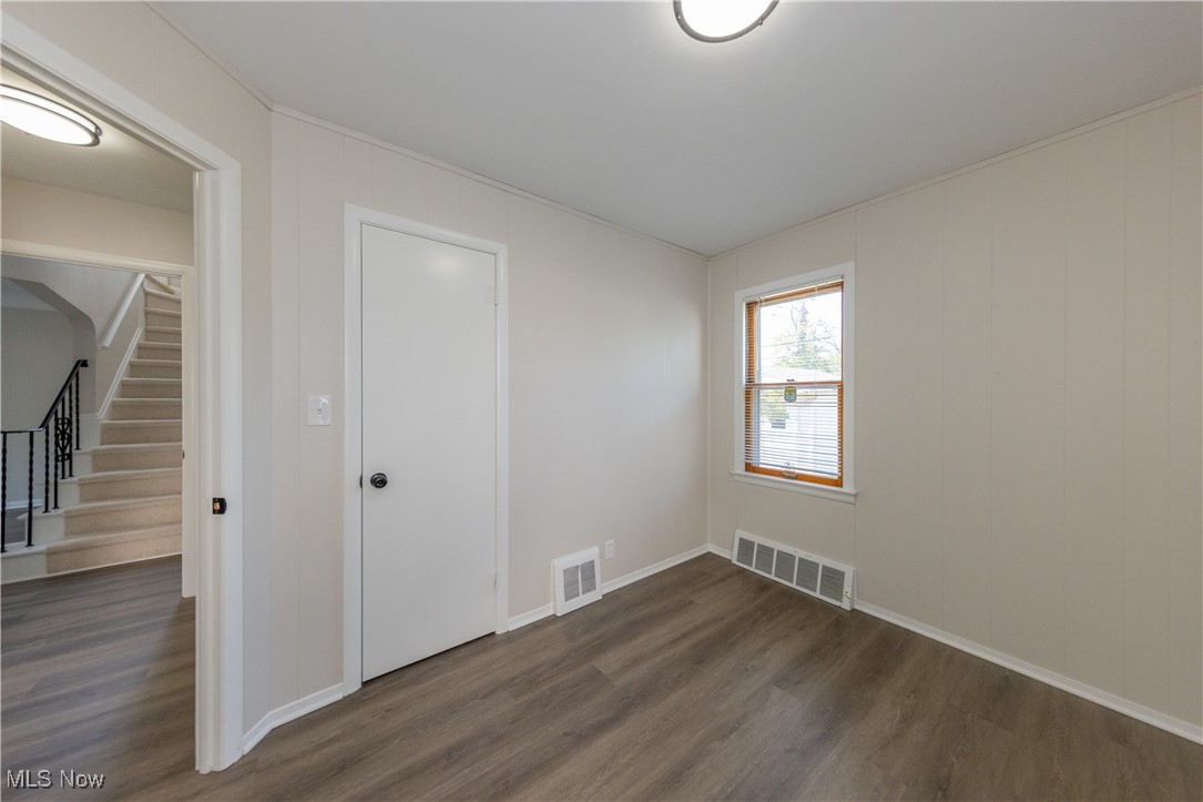 29103 Barjode Road Eastlake, OH 44095 - Photo 8 of 31 Unfurnished room with stairs and dark wood-style flooring