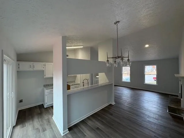a living room with hard wood floors and a window