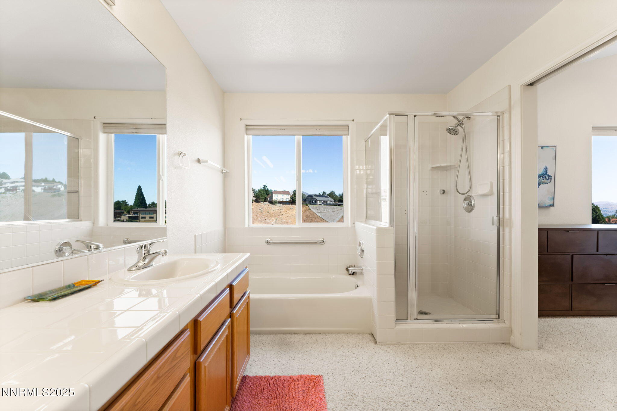2255 Wide Horizon Drive Reno, NV 89509 - Photo 21 of 52 a bathroom with a tub sink shower and a mirror