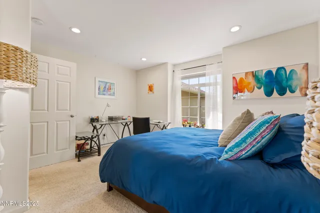 a bed room with a bed and a chair