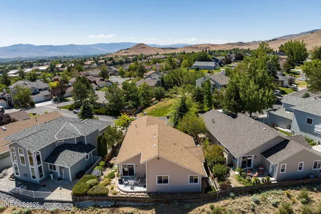 an aerial view of a house with a mountain view
