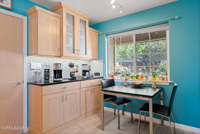 a kitchen with a sink cabinets and wooden floor