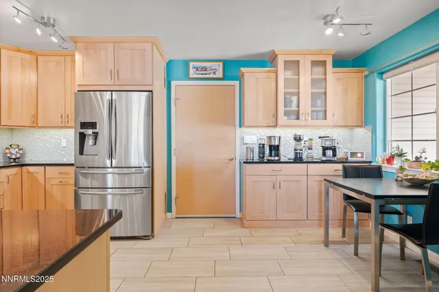 a kitchen with stainless steel appliances granite countertop a refrigerator sink and cabinets