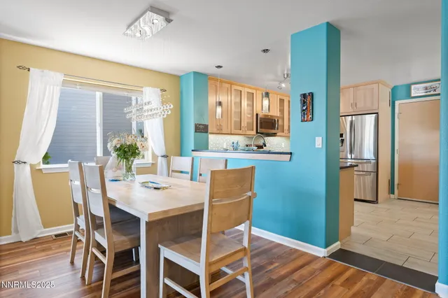 a dining room with furniture a window and wooden floor