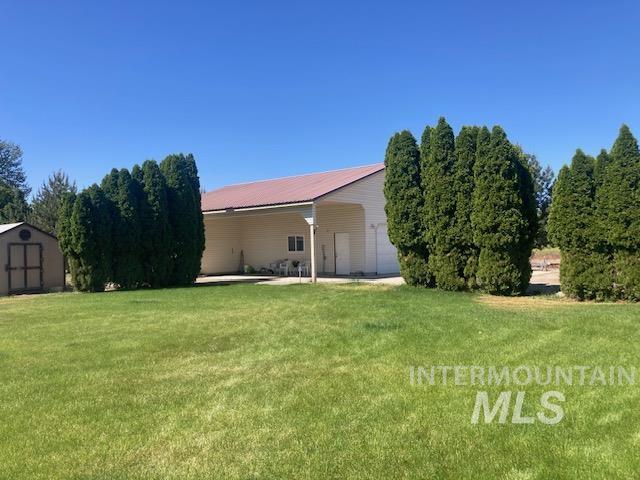 1095 County Road 70 Weiser, ID 83672 - Photo 42 of 44 Expansive green lawn with established trees bordering the property
