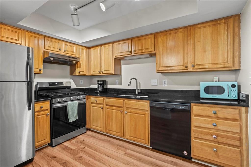 3301 Henderson Mill Road, Unit L4 Atlanta, GA 30341 - Photo 13 of 33 a kitchen with granite countertop stainless steel appliances and wooden cabinets