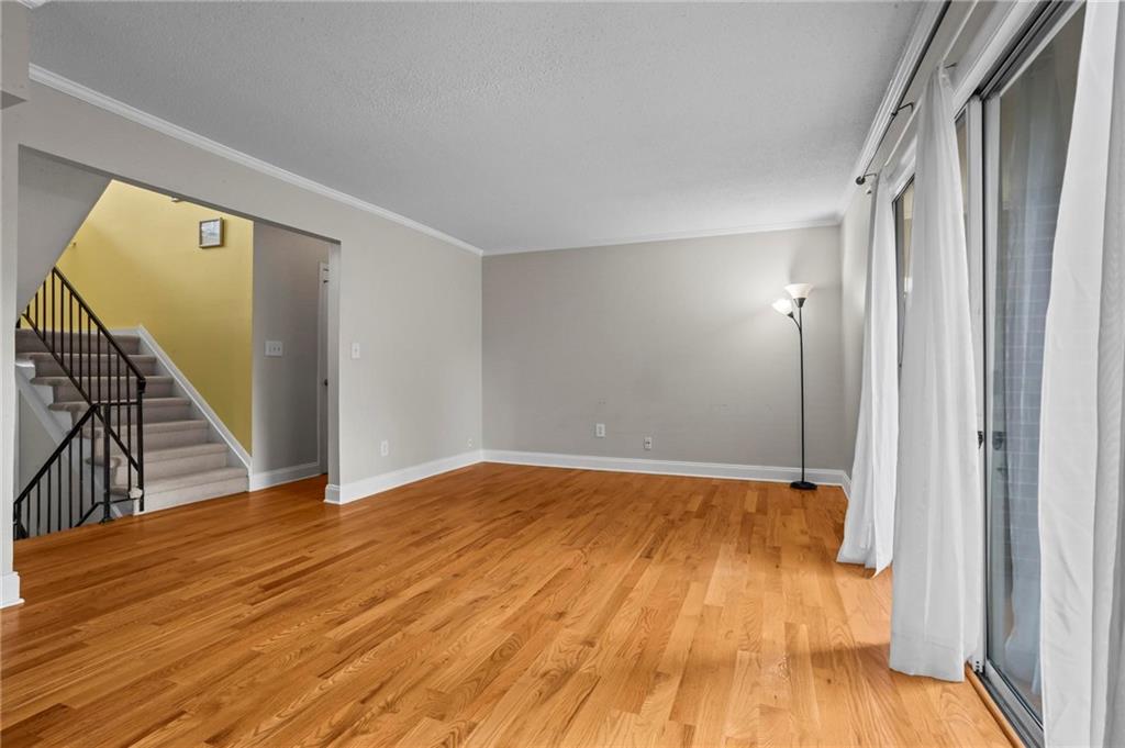 3301 Henderson Mill Road, Unit L4 Atlanta, GA 30341 - Photo 6 of 33 a view of empty room with wooden floor and fan