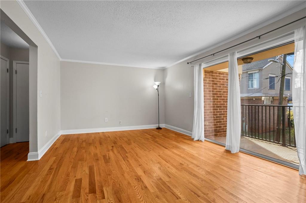3301 Henderson Mill Road, Unit L4 Atlanta, GA 30341 - Photo 8 of 33 a view of empty room with wooden floor and fan