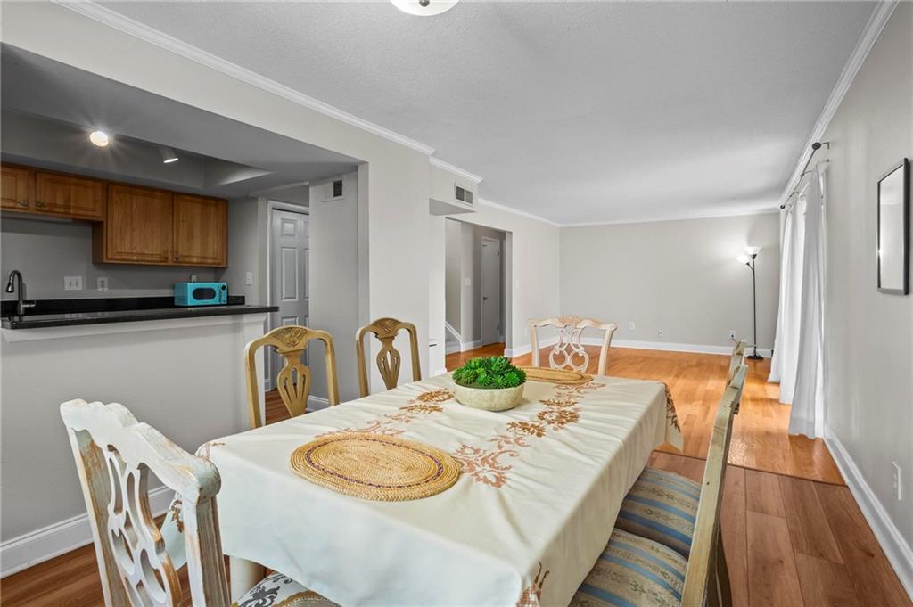 3301 Henderson Mill Road, Unit L4 Atlanta, GA 30341 - Photo 10 of 33 a dining room with furniture and wooden floor