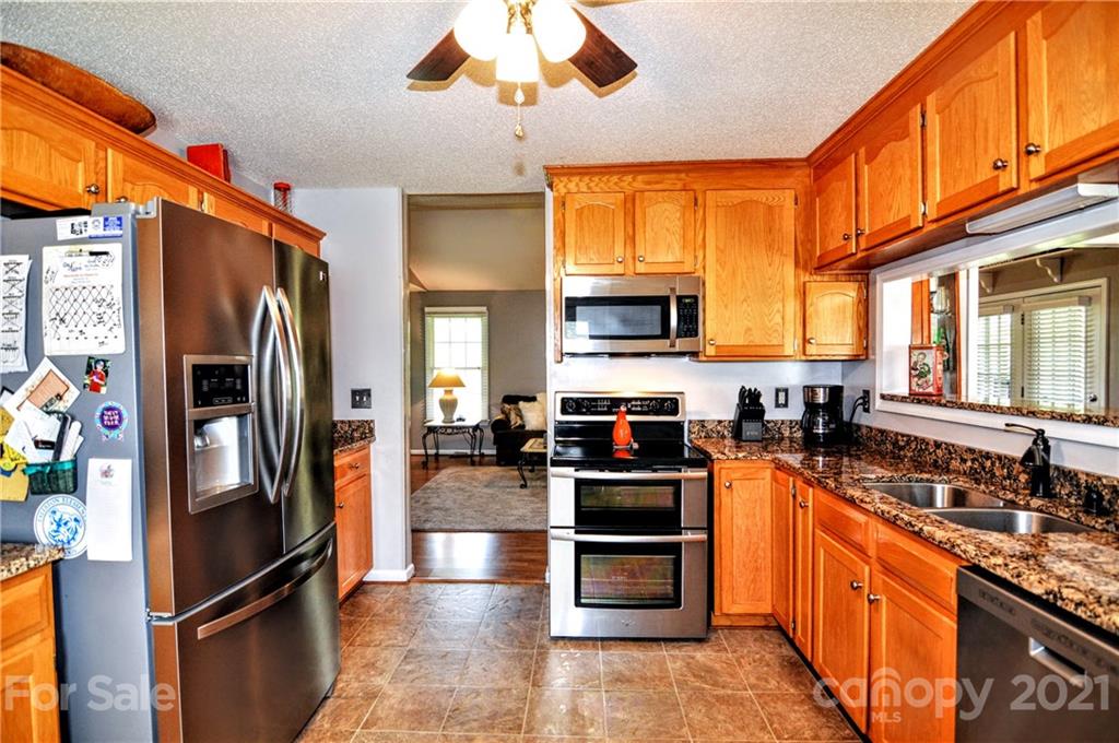 3874 Redman Road Shelby, NC 28150 - Photo 14 of 47 a kitchen with stainless steel appliances granite countertop a refrigerator stove and sink