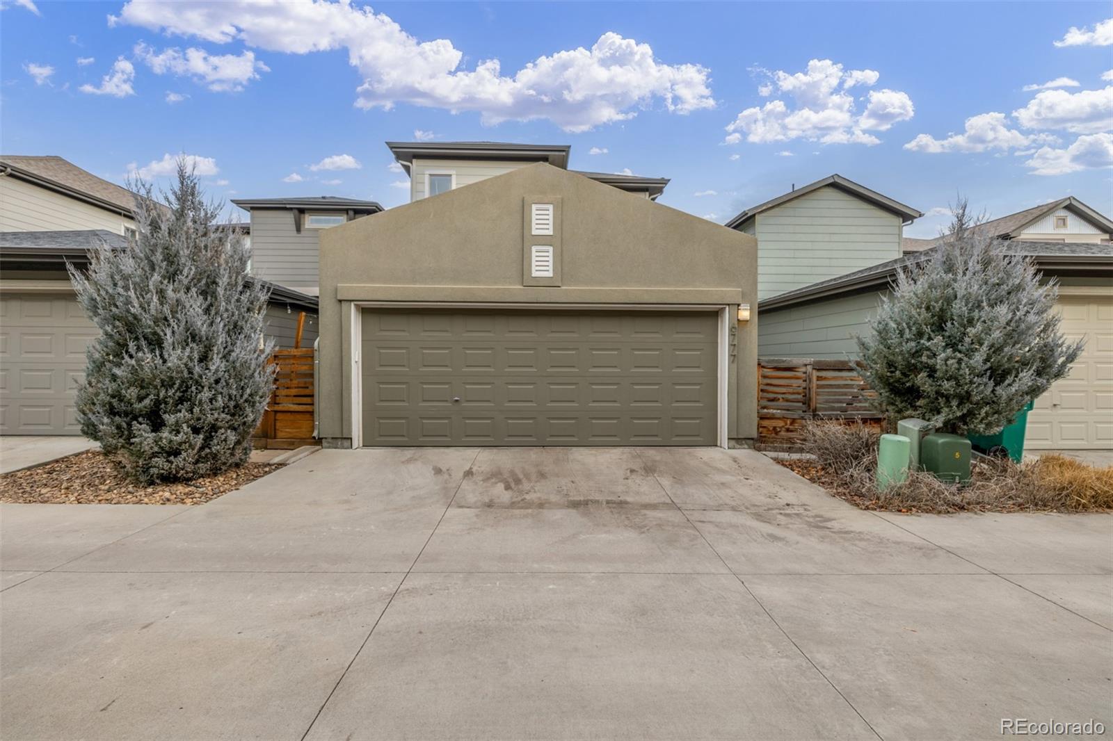 6777 Larsh Drive Denver, CO 80221 - Photo 37 of 48 a front view of a house with a yard and garage