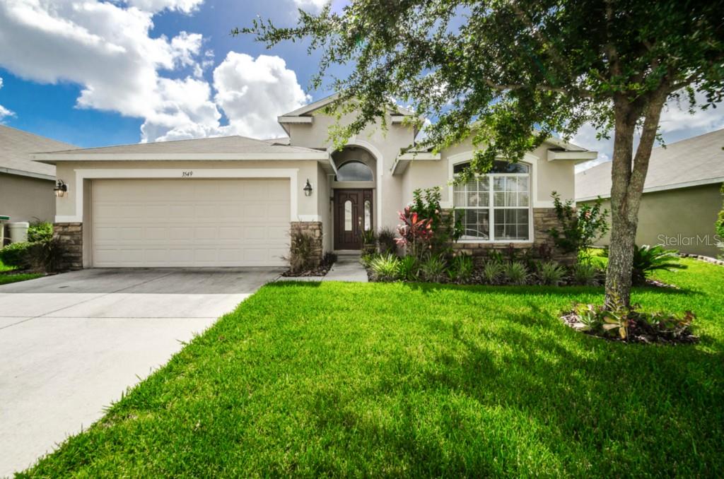 3549 Beaumont Loop Spring Hill, FL 34609 - Photo 1 of 1 a front view of a house with garden