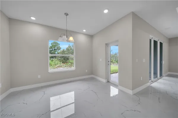 a view of a kitchen with a large window cabinets and a ceiling fan