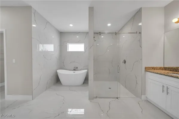 a bathroom with a granite countertop sink a toilet and bathtub