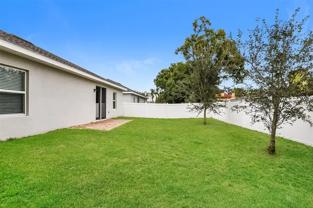 a view of a backyard with large trees