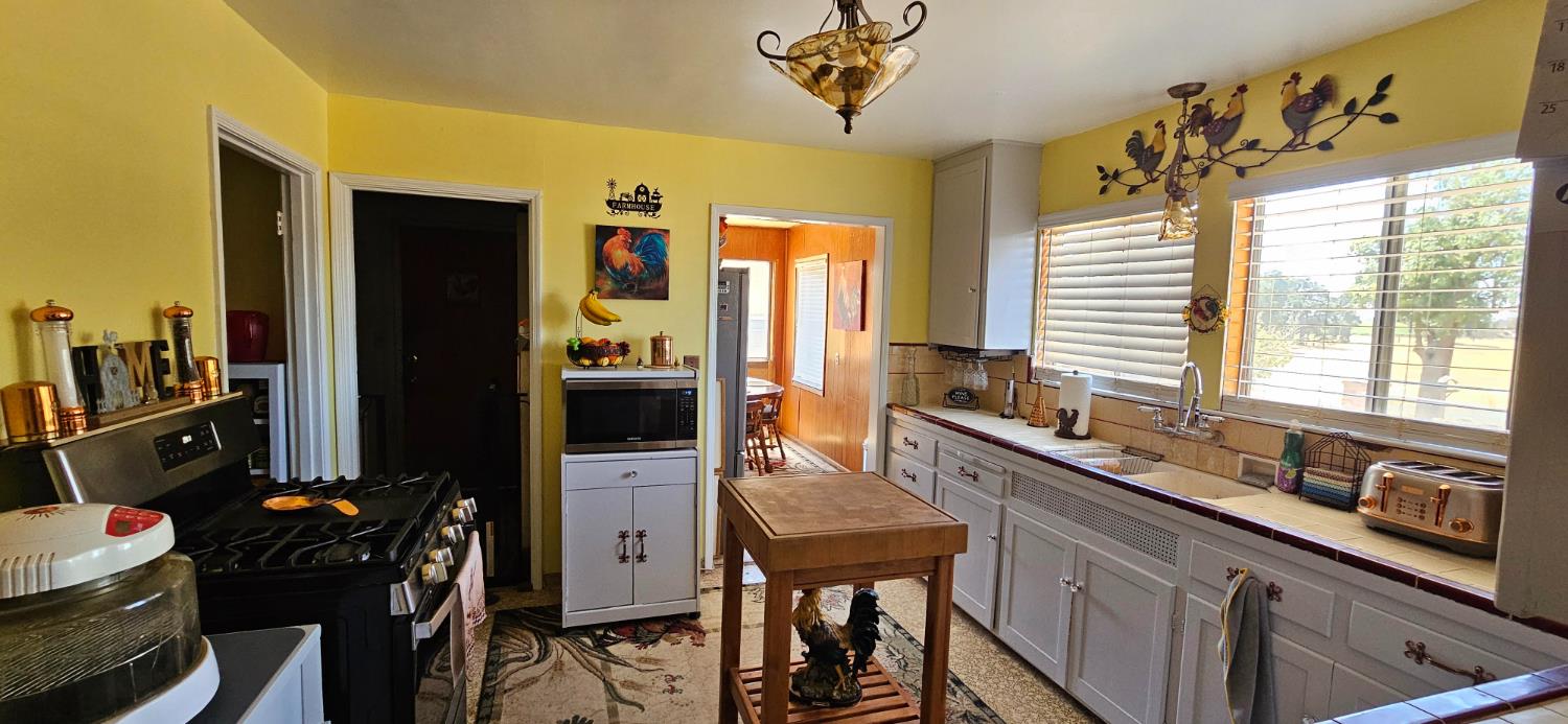 20822 Disch Road Lockeford, CA 95237 - Photo 8 of 30 a kitchen with a sink stove and refrigerator