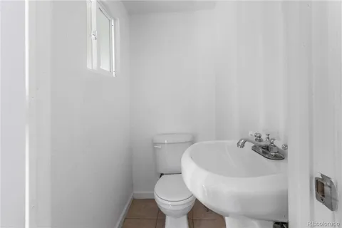 a white toilet sitting next to a white sink