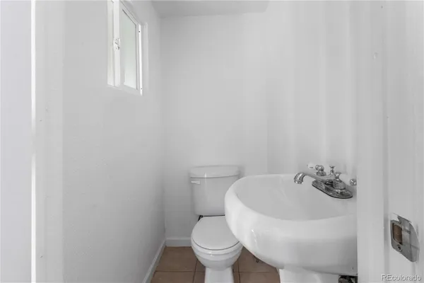 a white toilet sitting next to a white sink