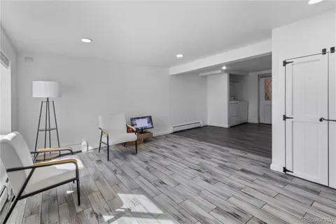 a view of a room with wooden floor and chair