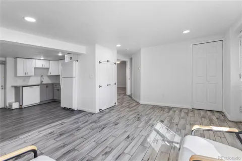 a view of a kitchen with wooden floor and a sink
