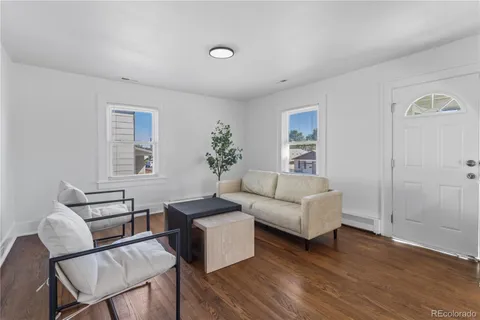 a living room with furniture and wooden floor