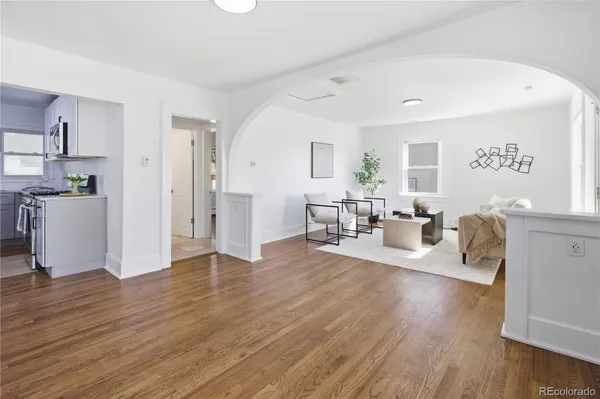 a living room with furniture and wooden floor