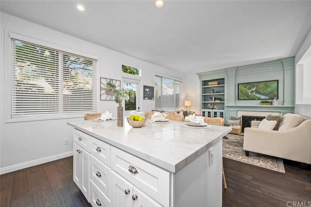 4350 Milano Way Oceanside, CA 92057 - Photo 11 of 30 a view of kitchen island a sink wooden floor and windows