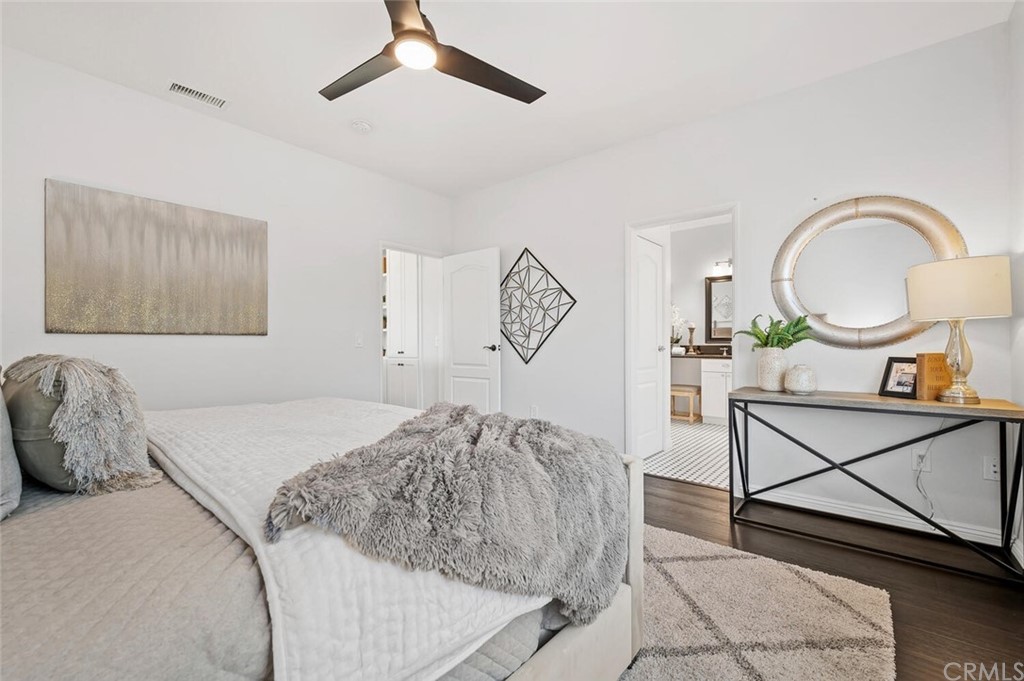 4350 Milano Way Oceanside, CA 92057 - Photo 15 of 30 a bedroom with a bed a mirror and lamp on the dresser