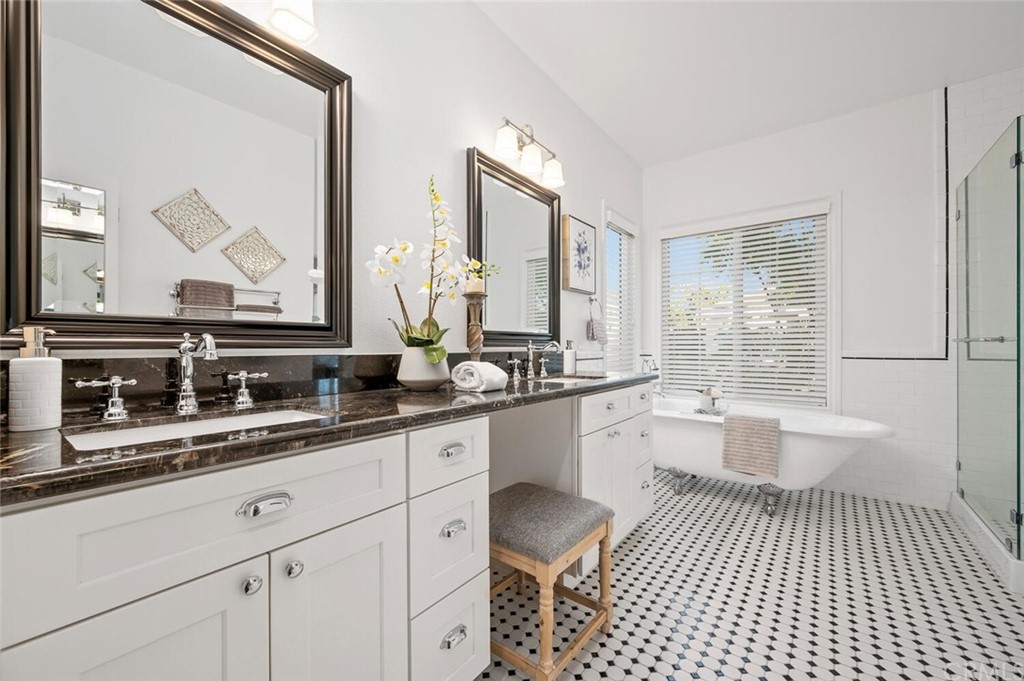4350 Milano Way Oceanside, CA 92057 - Photo 16 of 30 a large white bathroom with a double vanity sink a mirror a window and a bathtub