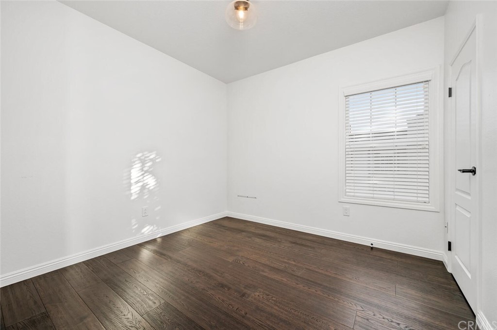 4350 Milano Way Oceanside, CA 92057 - Photo 22 of 30 an empty room with wooden floor and windows
