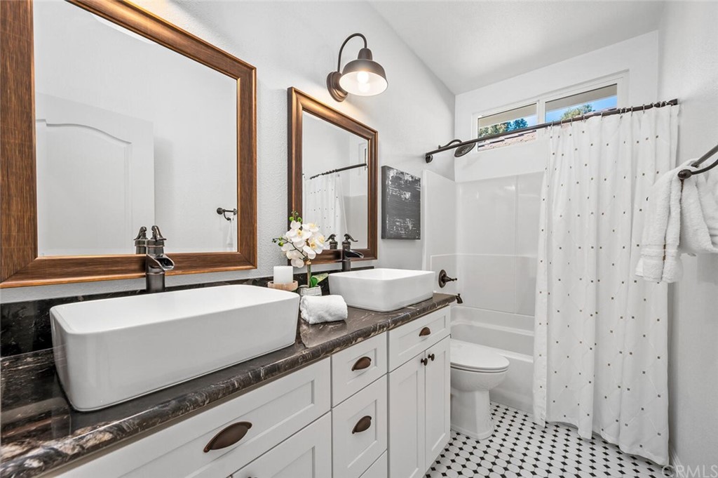4350 Milano Way Oceanside, CA 92057 - Photo 23 of 30 a bathroom with a granite countertop sink and a mirror