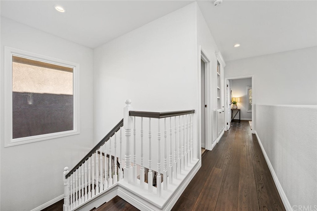 4350 Milano Way Oceanside, CA 92057 - Photo 24 of 30 a view of a hallway with wooden floor and staircase