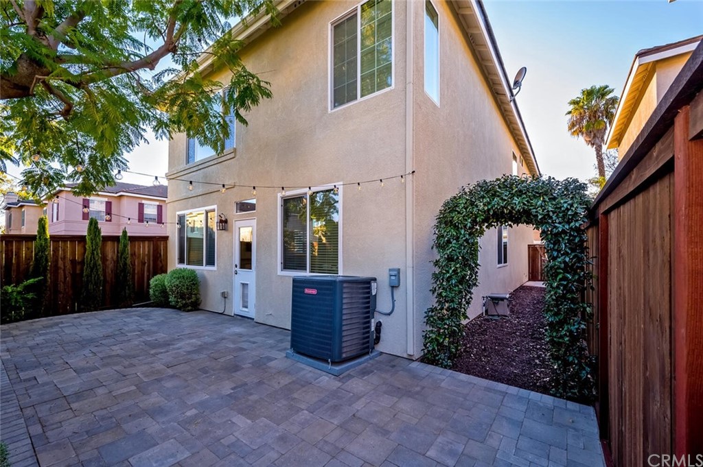 4350 Milano Way Oceanside, CA 92057 - Photo 26 of 30 a view of backyard with potted plants and a large tree