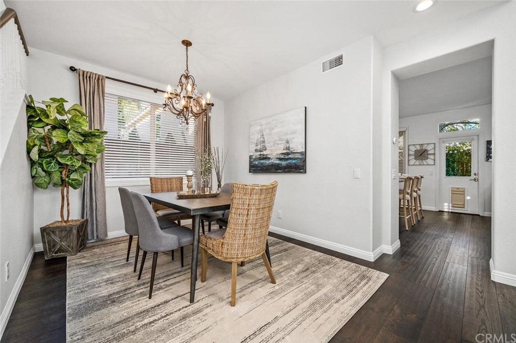 4350 Milano Way Oceanside, CA 92057 - Photo 5 of 30 a dining room with furniture potted plants and wooden floor