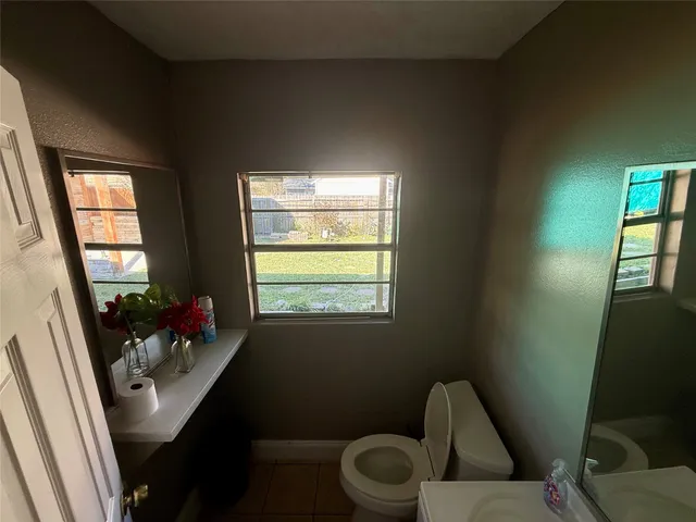 a view of room with walk in closet and wooden floor