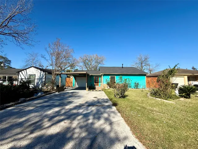 a view of a patio with a table and chairs under an umbrella